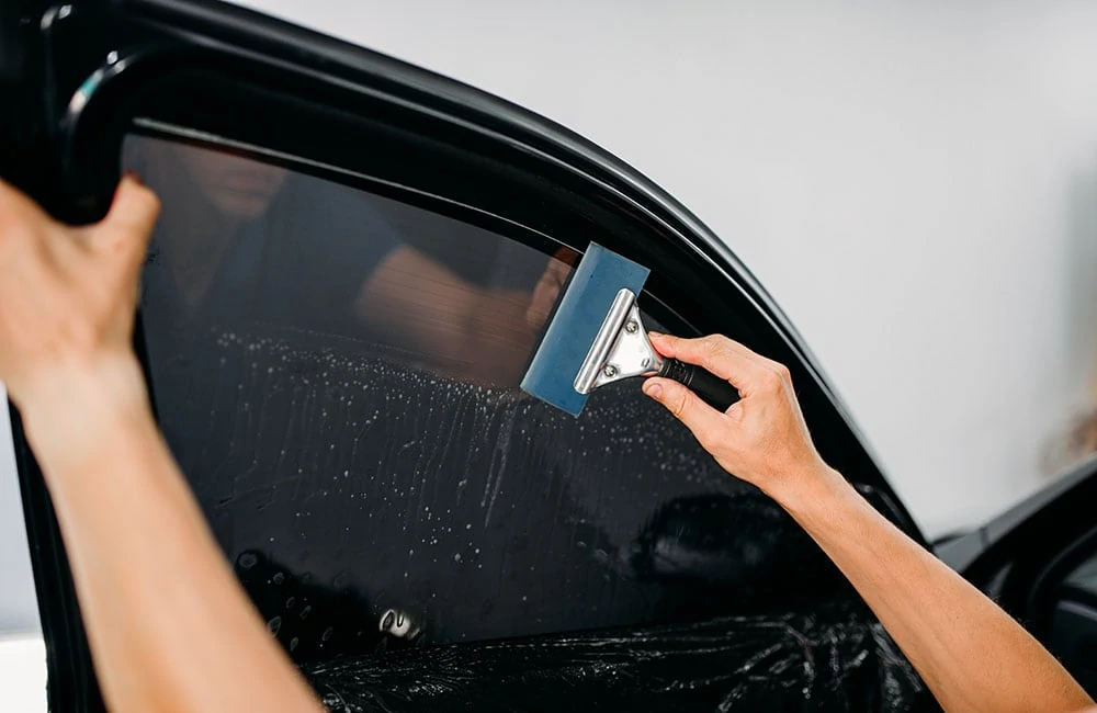 Front side window tint on a vehicle, showing the legal 33 percent shade